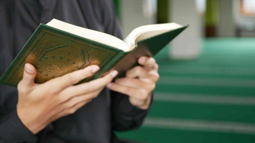 Person reading Quran in masjid